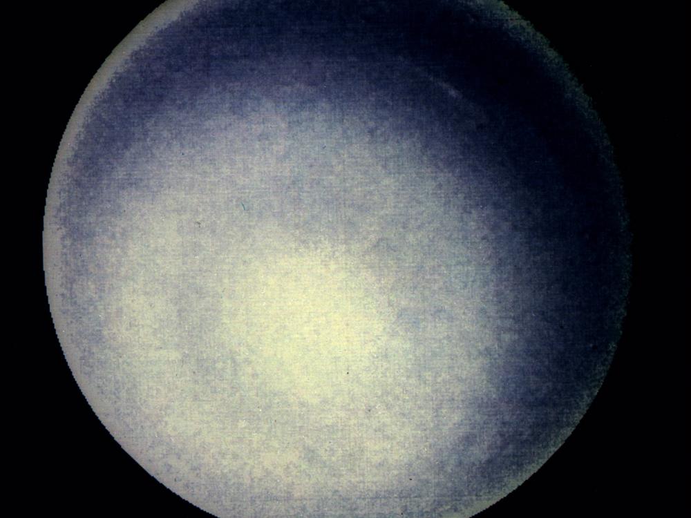 A hazy blueish orb against a dark background.