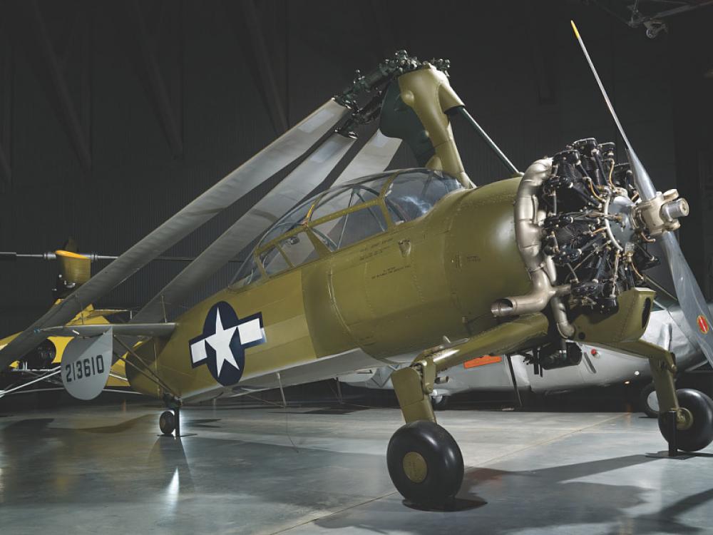 An olive green autogiro with the Air Force symbol on the side. 