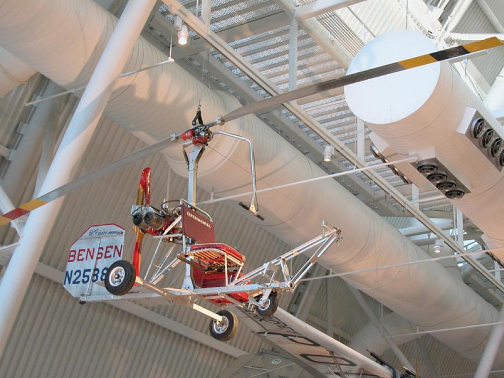 What looks like a seat with a small rudder and with two giant blades suspended above it. 