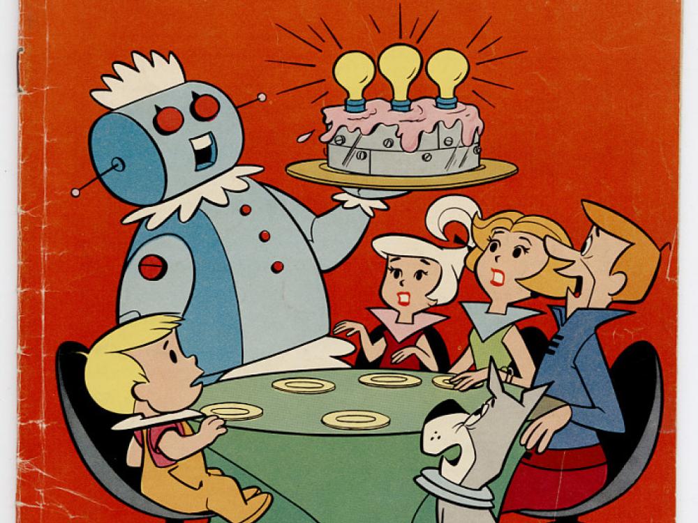 A red comic book cover showing a family gathered round a table, with a robot bringing a metallic cake to the family. 