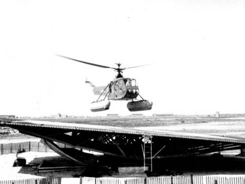 A black and white photograph of a helicopter with floats. 