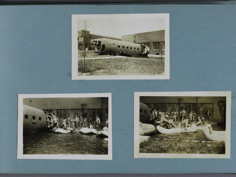 Three black and white photographs on a light blue scrapbook page. Top center photograph of an airplane fuselage. Bottom left photograph of women standing on the ground outside the fuselage. Bottom right photograph of women in boats on the ground outside the fuselage.