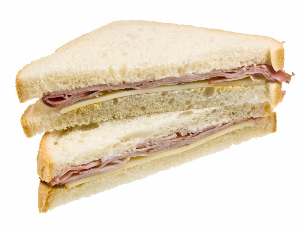 A sandwich cut triangle style with ham and cheese in the inside.