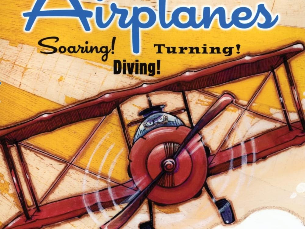 A book cover with the title "Airplanes: Soaring! Diving! Turning!" shows a red biplane being piloted.