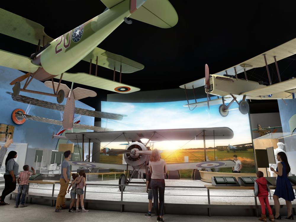 A rendering of a museum gallery featuring different planes from world war one suspended from the ceiling and in display.