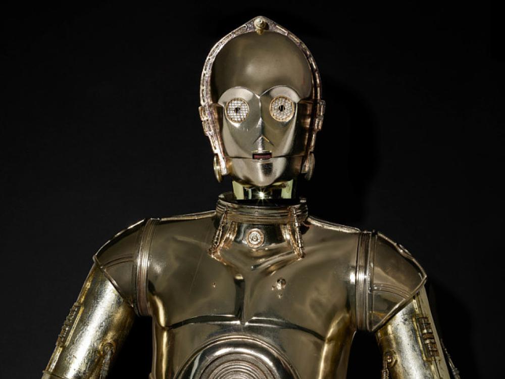 A gold humanoid shaped robot. 