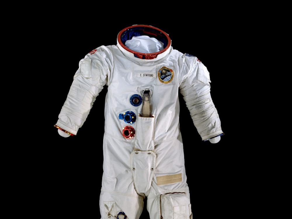 A spacesuit pictured against a black backdrop.