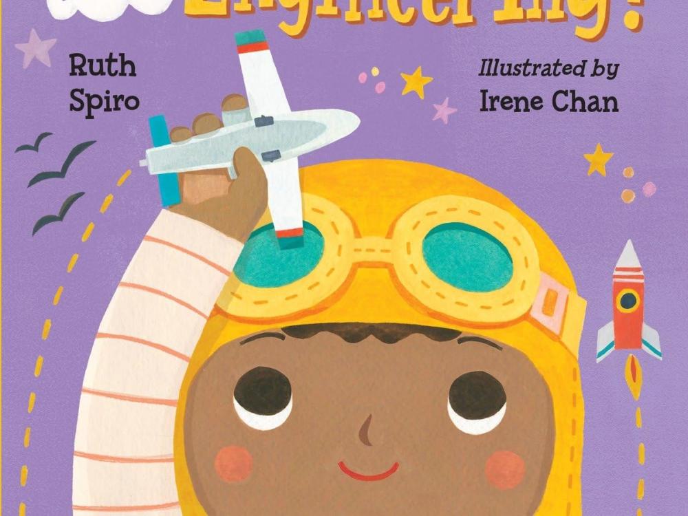 A book cover with a child with an airplane and the text "Baby Loves Aerospace Engineering"