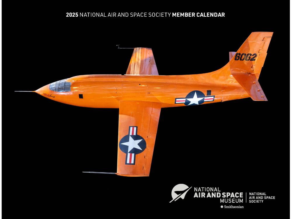 A black calendar cover with an orange plane on it. 