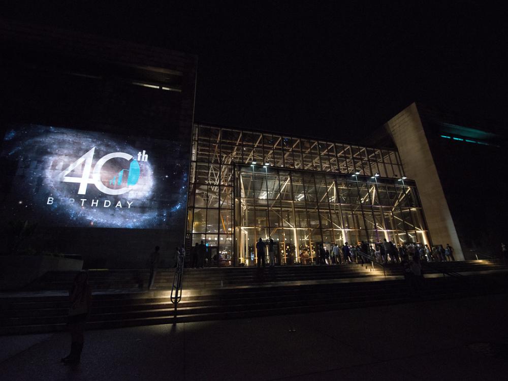 Image of the building with a projection on the exterior. 