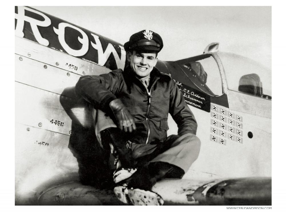 Bud Anderson, a white man, sits on the wing of an airplane.