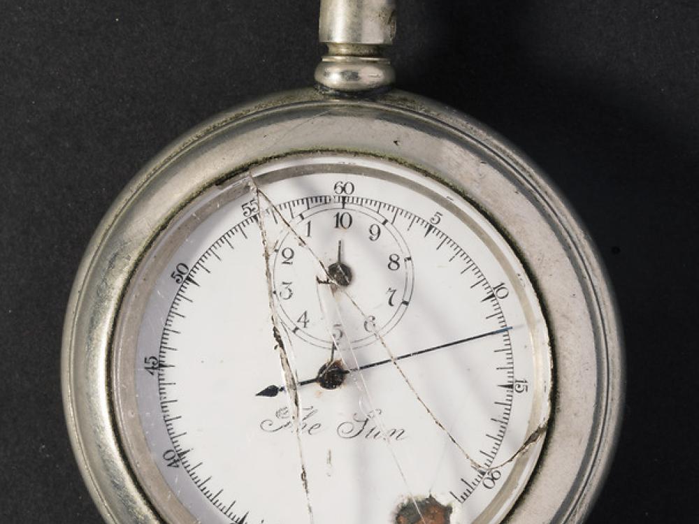 Broken stopwatch with hand pointed at nine-minute mark. 