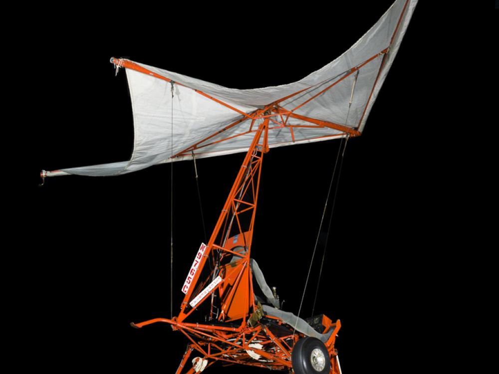 Small one-man glider made of steel tubing with 3 tires and parasail.