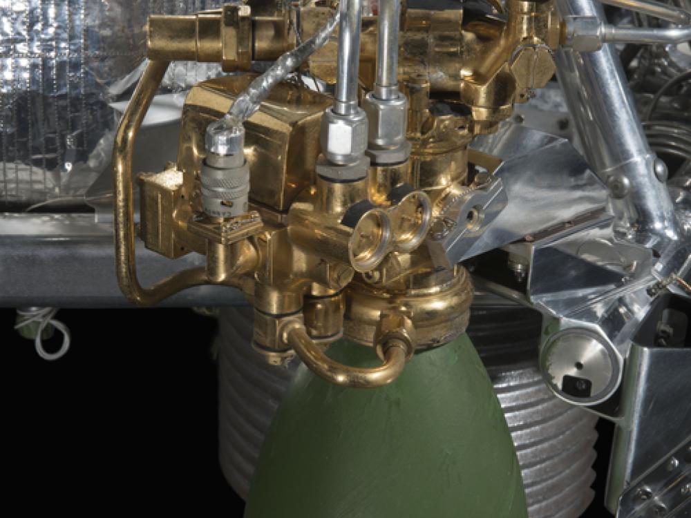 Green painted engine attached to a spacecraft. 