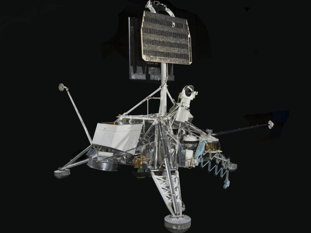 Engineering model with three-legged frame and mixed metals in landing position.