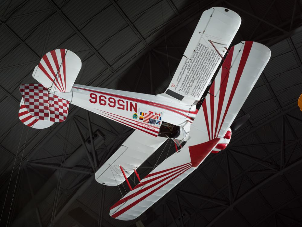 Single-engine white biplane with red accents, registration number N15696