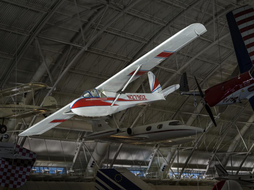 Red and white plane hanging in the museum. N2790Z is painted on the side of the plane.