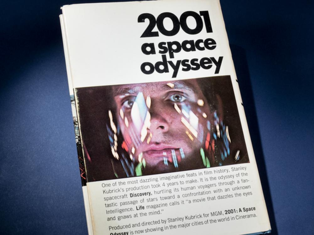 A book titled 2001 A Space Odyssey with a human face on the cover. 