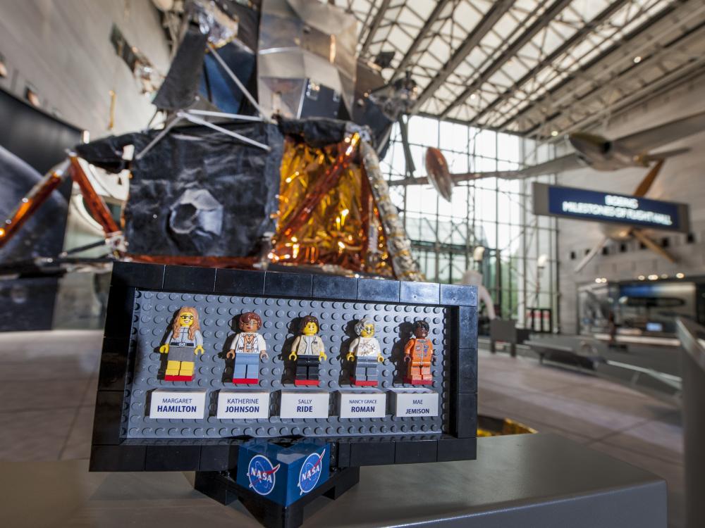 The original prototypes of the LEGO® Ideas "Women of NASA" set displayed in front of the Apollo Lunar Module in the Boeing Milestones of Flight Hall 