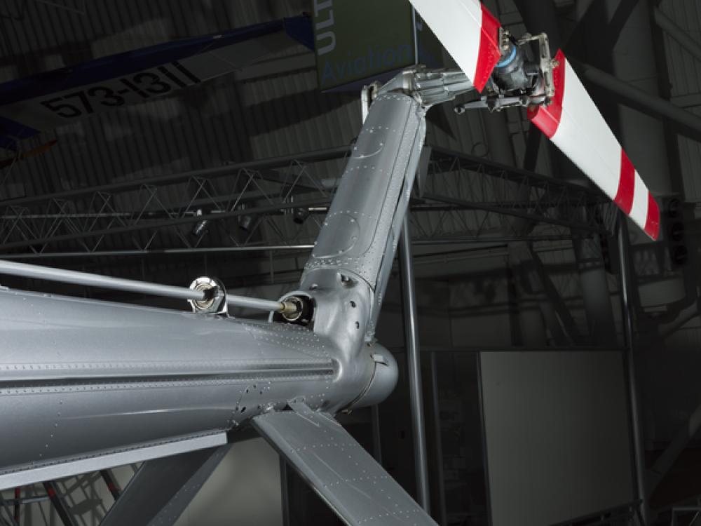 View of a red and white painted tail rotor on a helicopter.