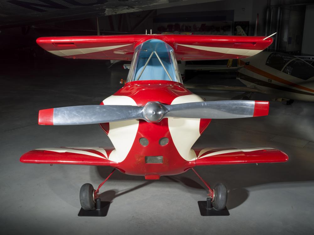 Nose of a red and white painted smallest man-carrying plane.