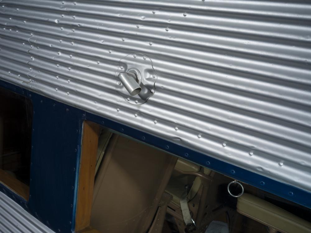 Close up of a window looking into the passenger cabin on a plane. 