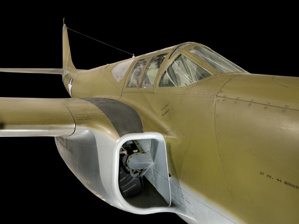 Close up view of the cockpit and intake valve of a jet plane.