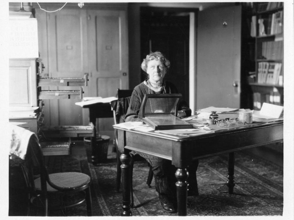 Black and white photo of Cannon at her desk. 