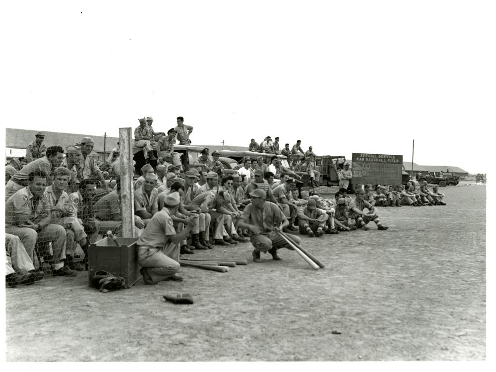 A large group of people view a baseball game played in India.