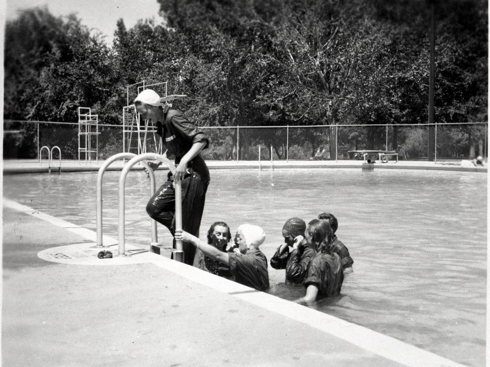 Female pilots-in-training in the process of exiting a swimming pool following a swimming lesson.