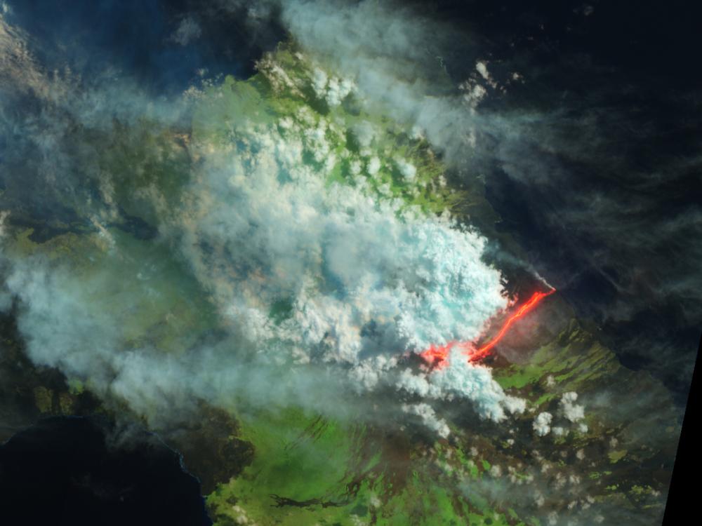 Satellite view of an erupting volcano in the Galapagos Islands. The view has been edited to show different colors which represent different aspects of the photo.