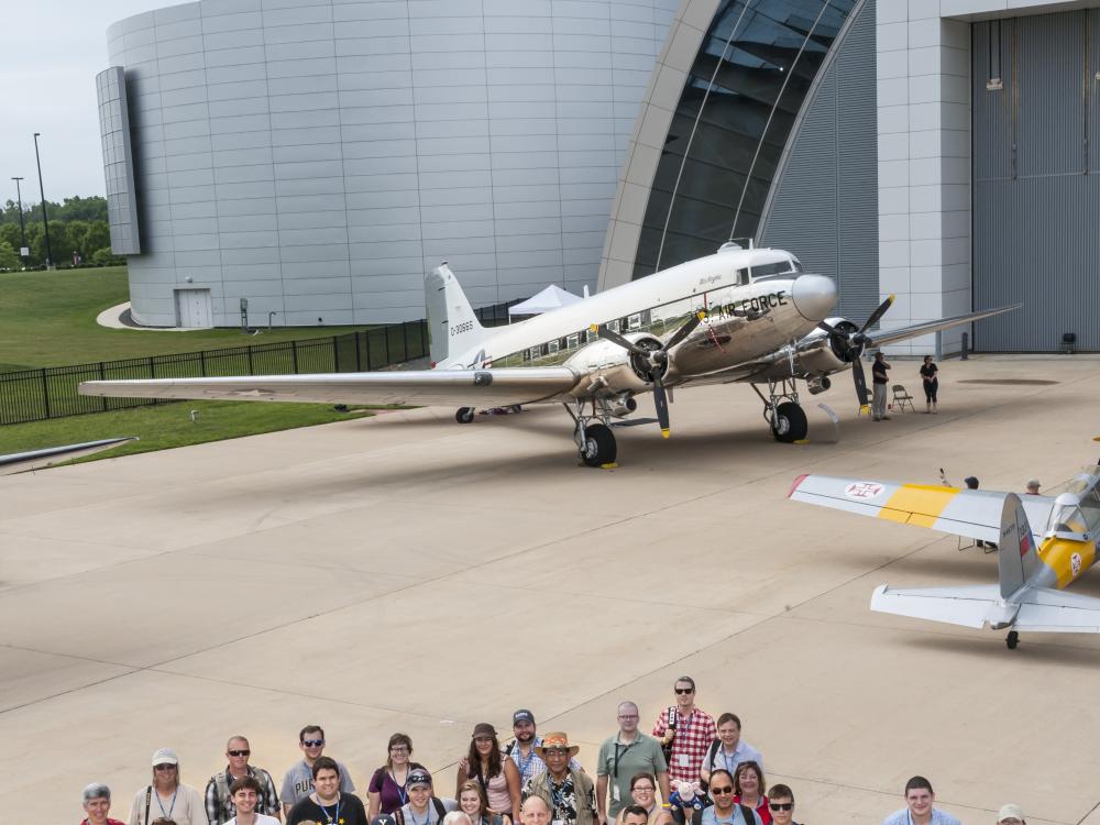 Group photo of social media participants, social media staff members of the Museum, the Museum's former director, and astronaut Clay Anderson outside together during a flight-themed Museum event.