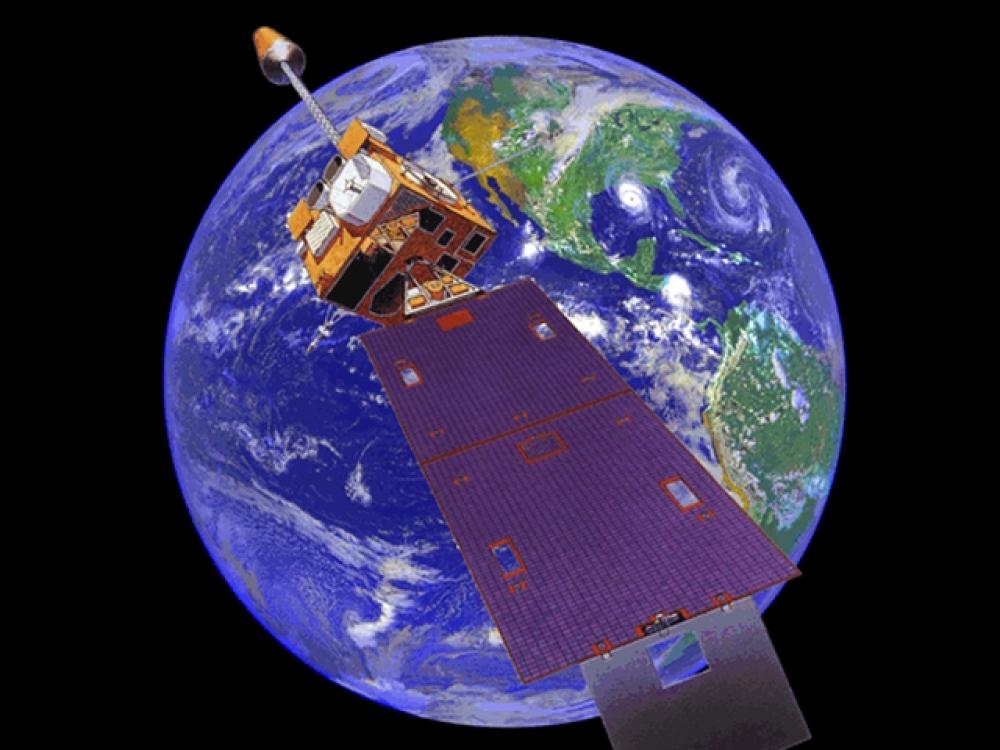 Animation of a satellite orbiting the Earth. The satellite has a box-shaped base and a large solar panel on one side.