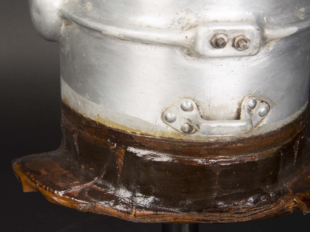 Close-up view of white-colored corrosion forming on the neck section of the first pressure suit helmet.