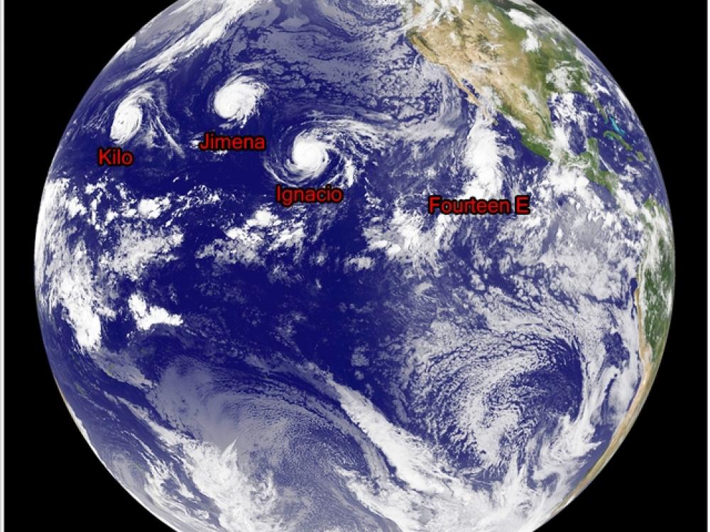 Disk view of the Earth focusing on the Pacific Ocean. Four tropical cyclones are labeled with their names in red text.