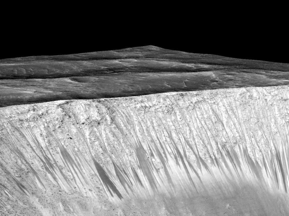 Darker-colored streak-like lines appear on the slope of a crater on Mars.