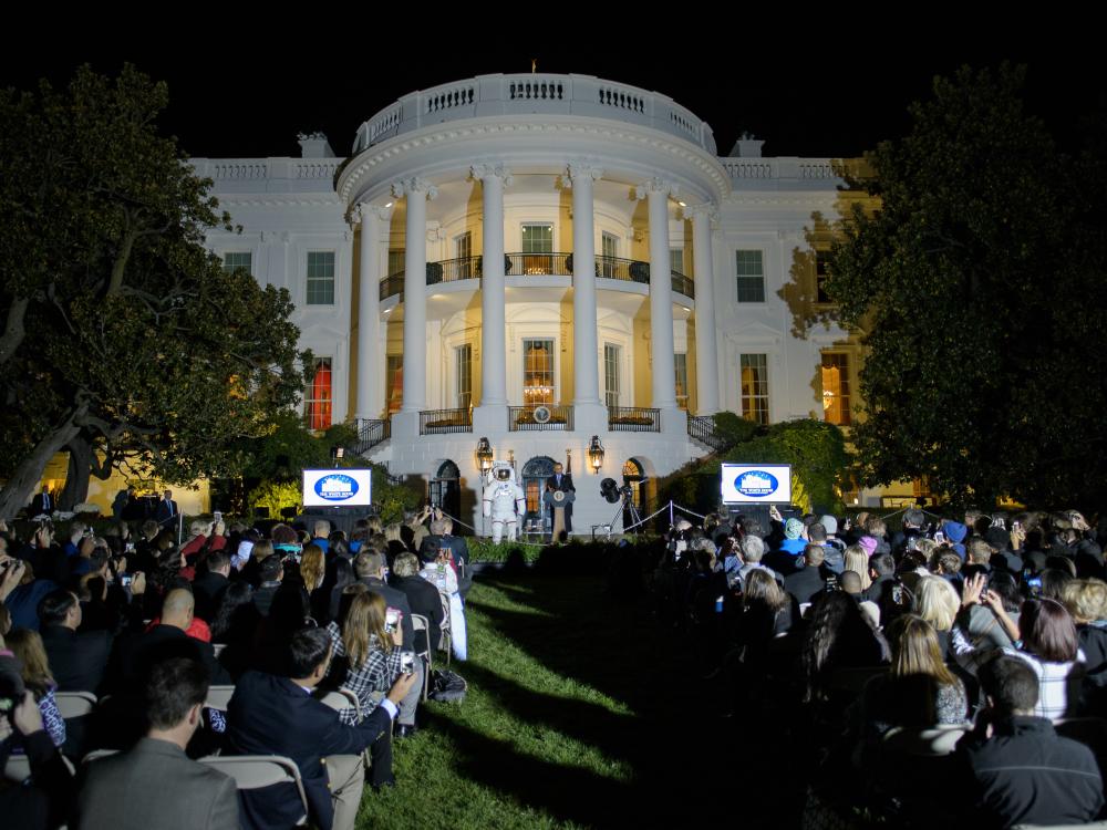 View of the White House exterior during an astronomy event held there. President Obama is speaking to a group of people.