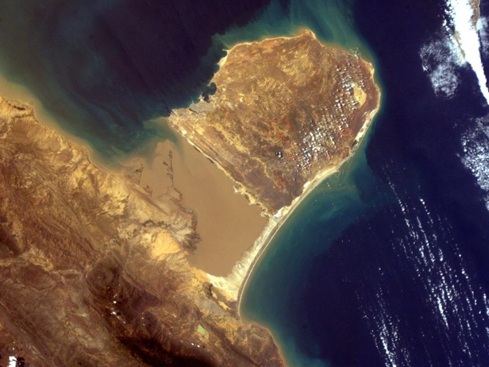 Satellite view of a peninsula with brown ground on the coast of Venezuela. 