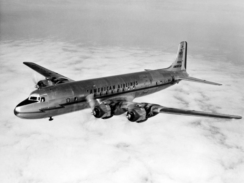 Side view of commercial aircraft in flight. Aircraft features four engines and American Airlines livery.