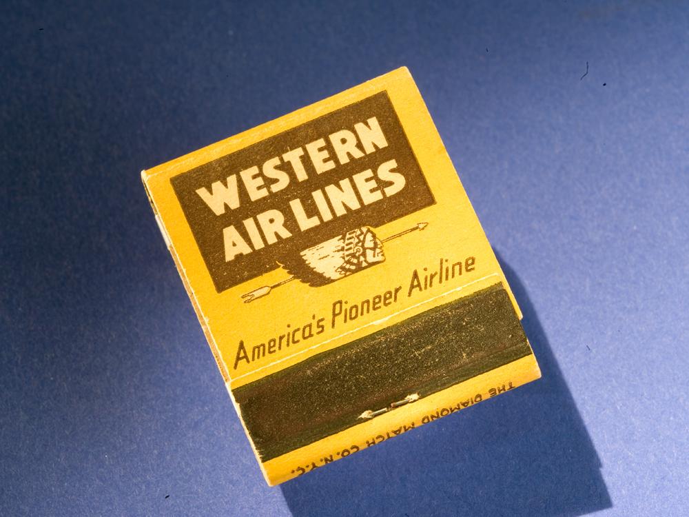 Matchbook with yellow background and brown Western Air Lines logo on cover. 