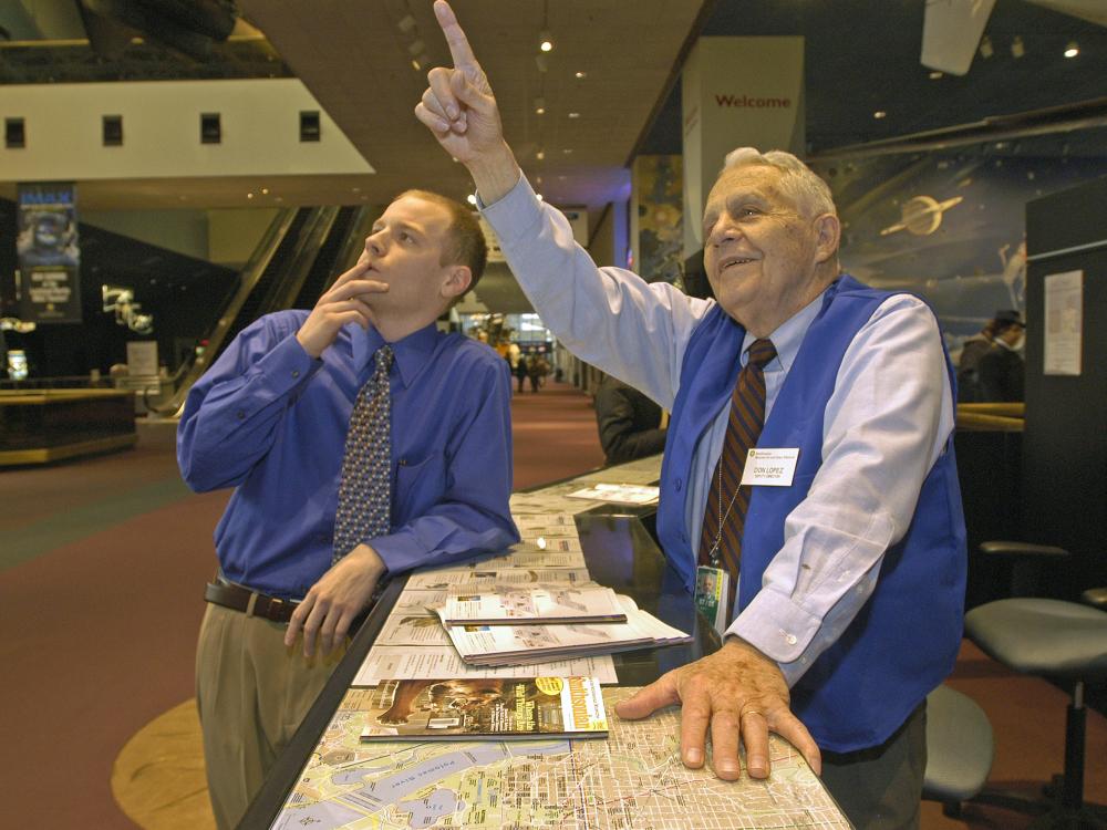 Don Lopez Helping Visitor at the Welcome Center