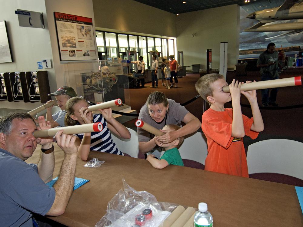 Visitors Look Through Telescopes at Explore the Universe Day