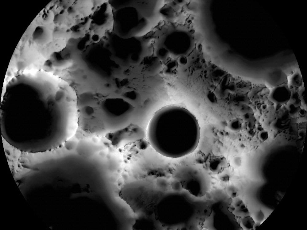 Map intended to illuminate the South Pole of the Moon. Multiple large dark spots are visible.