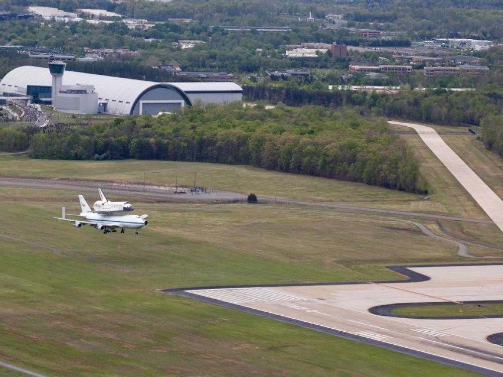 The Space Shuttle Discovery lands on a tarmac near the Udvar-Hazy Center .