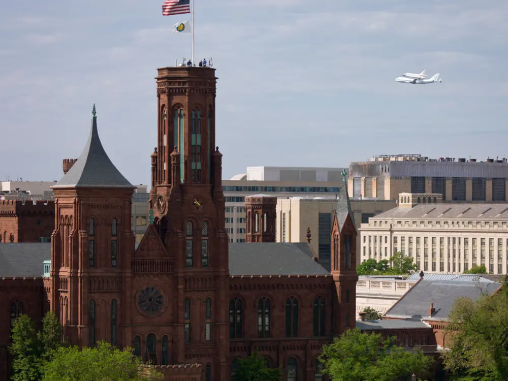 Space Shuttle Discovery Flies near the Smithsonian Castle