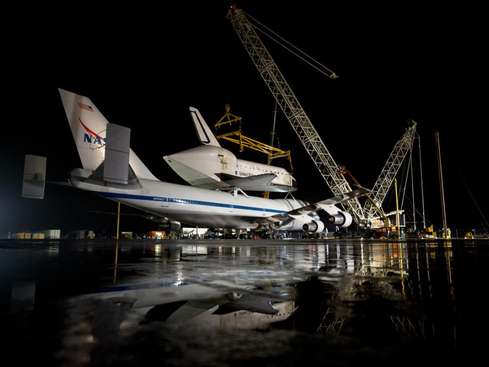 The Space Shuttle Discovery is prepared to be removed from the modified Boeing 747 used to transport the shuttle to the Udvar-Hazy Center.