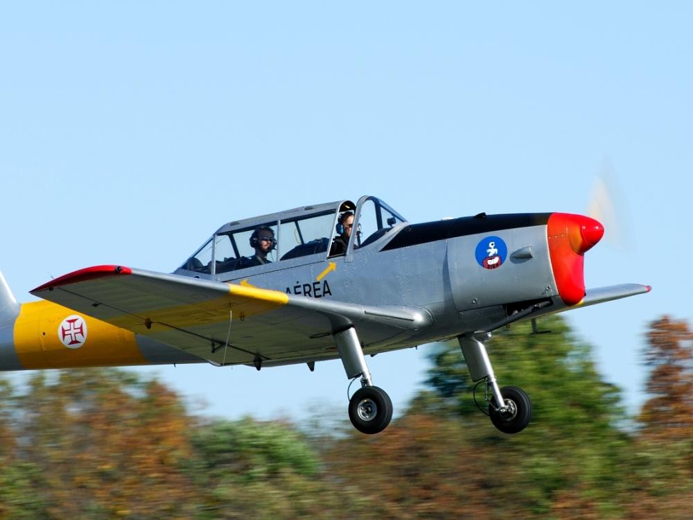 Side view of a silver and yellow aircraft with one propellor attached to the nose.