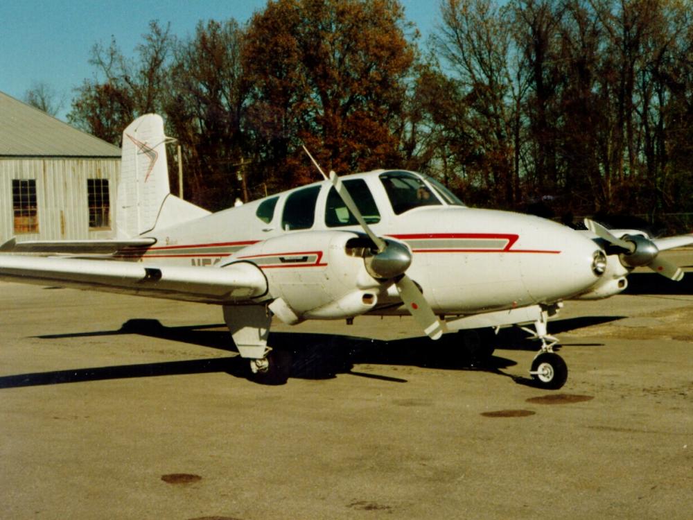 Side view of white monoplane with twin engines. 