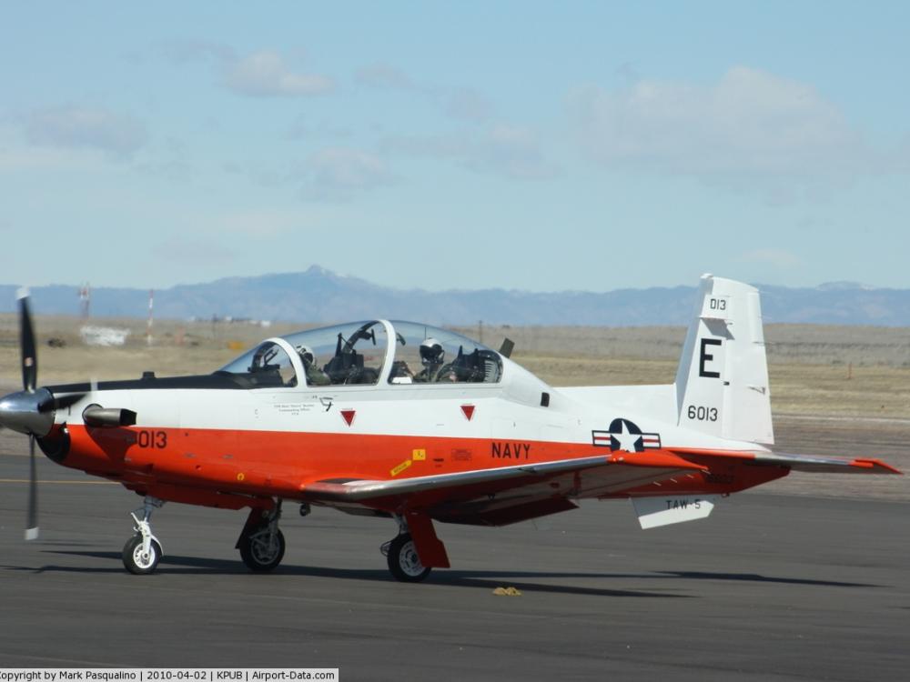 Side view of white and reddish-brown monoplane with one engine.