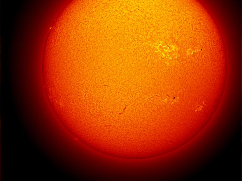 Disk view of the Sun's chromosphere with multiple sunspots visible on the surface of the Sun.